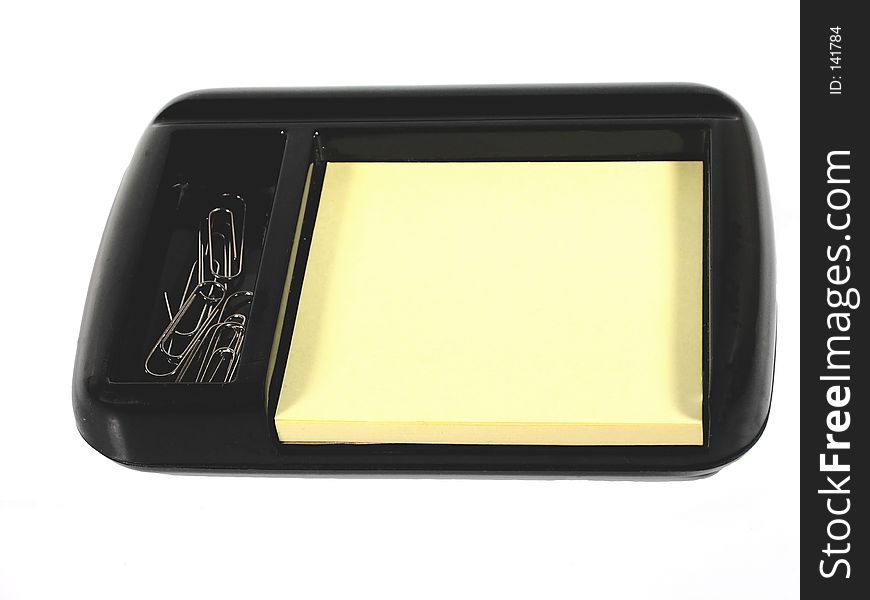 Desktop accessory for hold pad and paper clips; blank yellow pad. Desktop accessory for hold pad and paper clips; blank yellow pad