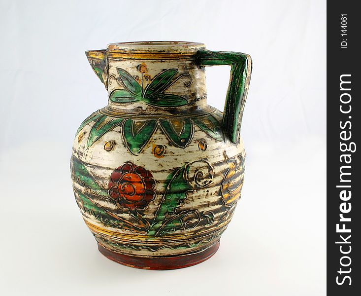 Isolated old jug decorated with colorful leaves and flowers. Isolated old jug decorated with colorful leaves and flowers