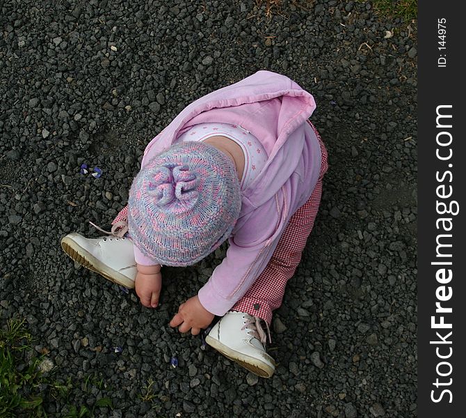 Girl playing with pebbles