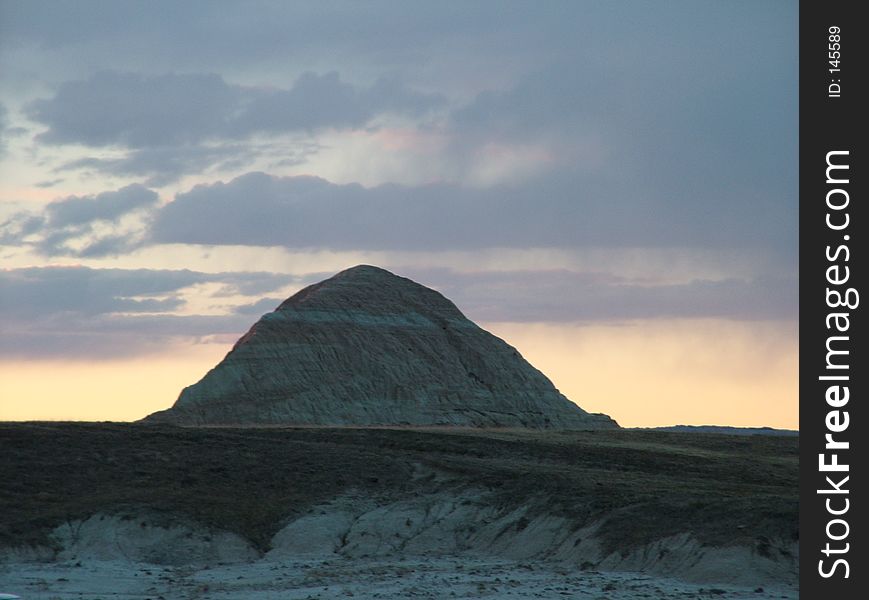 Sunset over a small mountain in the badlands of South Dakota. Sunset over a small mountain in the badlands of South Dakota.