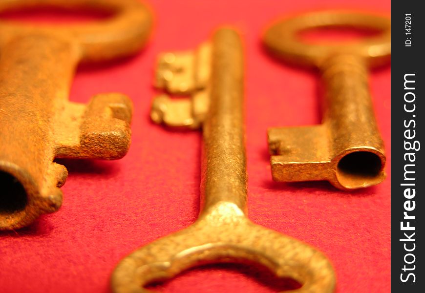 Antique Gold Keys on red background