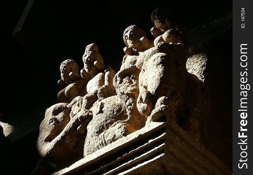 Rock cut Idols atop a pillar at Karla Caves, Pune, India. Rock cut Idols atop a pillar at Karla Caves, Pune, India
