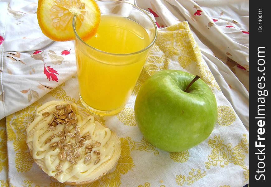 Green apple, vegetarian sandwich and fresh orange juice served in bed. Green apple, vegetarian sandwich and fresh orange juice served in bed