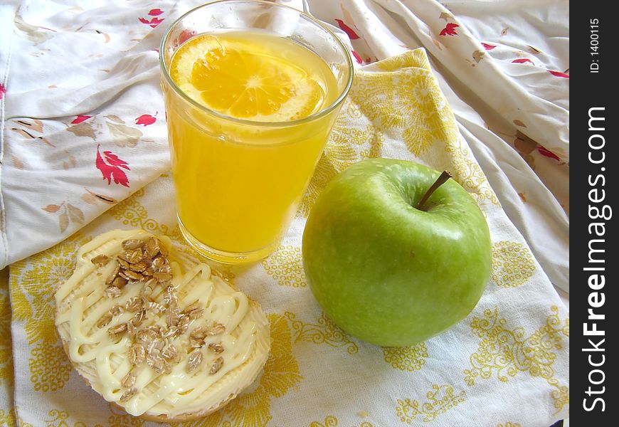 Green apple, vegetarian sandwich and fresh orange juice served in bed. Green apple, vegetarian sandwich and fresh orange juice served in bed