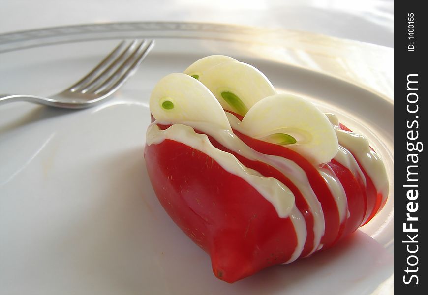 Gourmet diet dish with red paprika and garlic, decorated with mayonnaise dressing