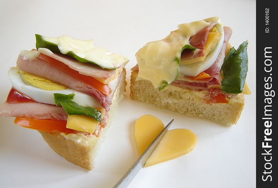 Delicious gourmet sandwich with ham, eggs, mayonnaise, salad, cheese and ketchup. Heart of cheese. Delicious gourmet sandwich with ham, eggs, mayonnaise, salad, cheese and ketchup. Heart of cheese.