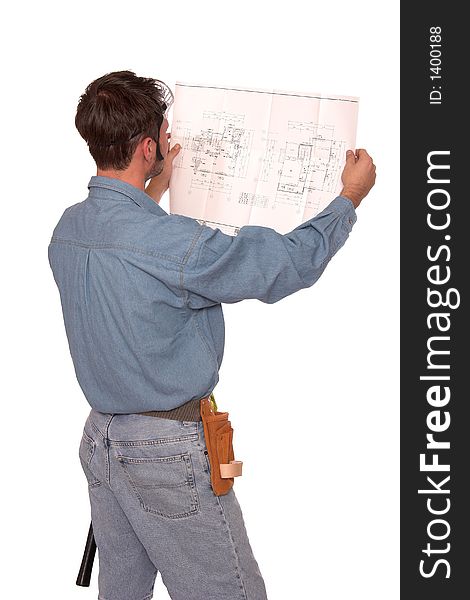Carpenter reading blueprints with back to the camera. Carpenter reading blueprints with back to the camera