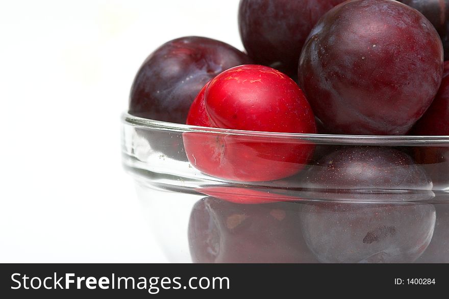 Bowl of Plums against a white background