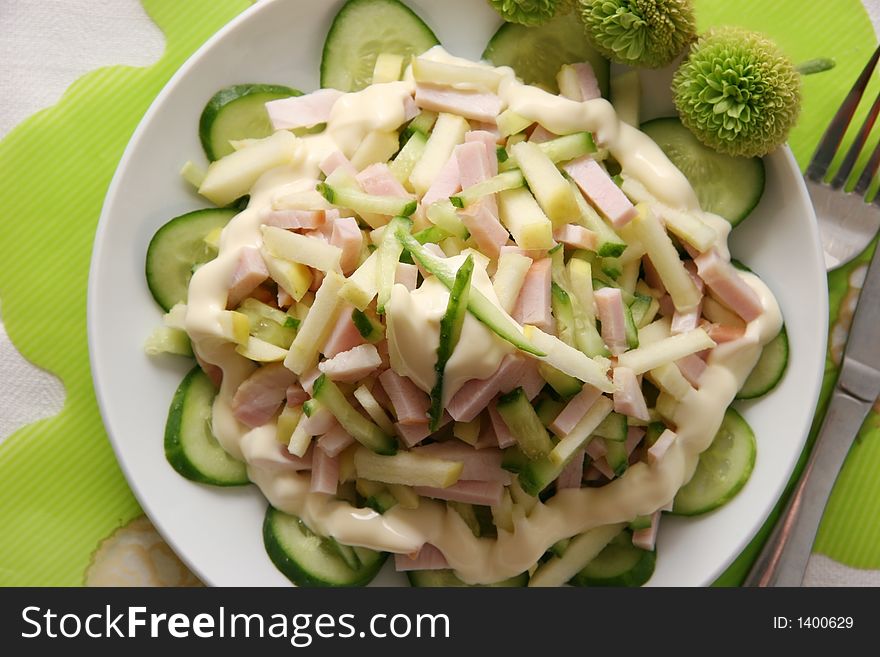 Salad made of ham, apples and fresh cucumbers. Salad made of ham, apples and fresh cucumbers.