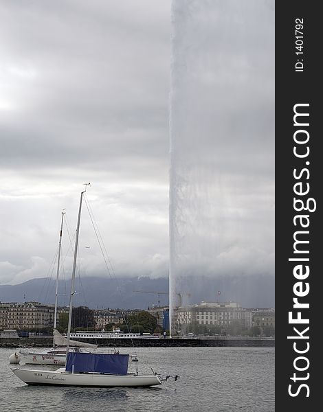 Powerful fountain on Lake Geneva on a very cloudy day. Powerful fountain on Lake Geneva on a very cloudy day