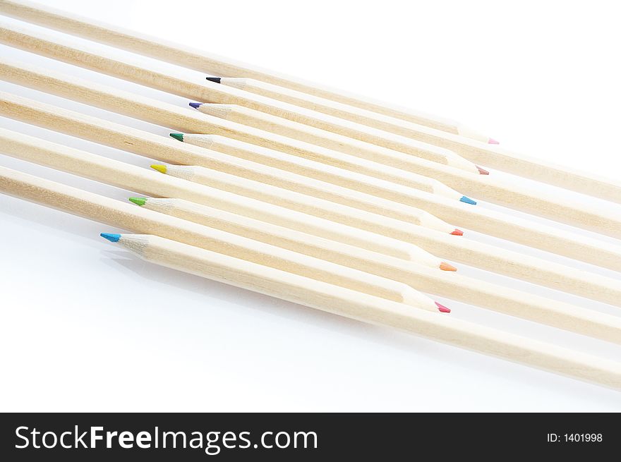 Line of colored pencils isolated on white background