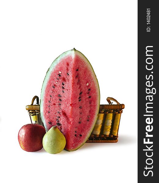 One slice of watermelon, one pear and one apple in front of a basket, isolated in white. One slice of watermelon, one pear and one apple in front of a basket, isolated in white.