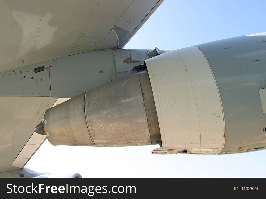 Detail of a jet turbine attached to a wing of a big passenger aircraft