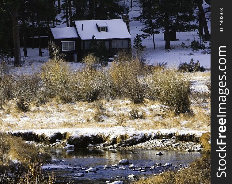 Small cabin inside national park with a light dusting of snow. Small cabin inside national park with a light dusting of snow.