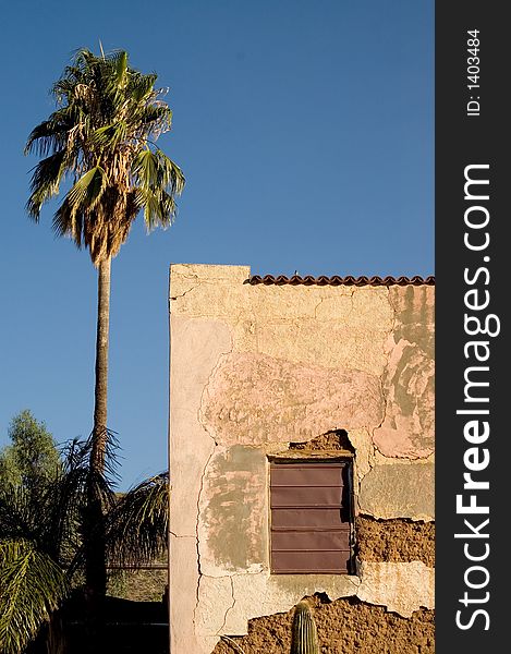 Historic motel in ruins wth lone palm tree standing next to it. Historic motel in ruins wth lone palm tree standing next to it