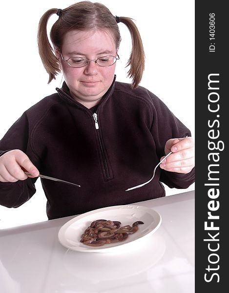 A woman eating a plateful of worms. A woman eating a plateful of worms.