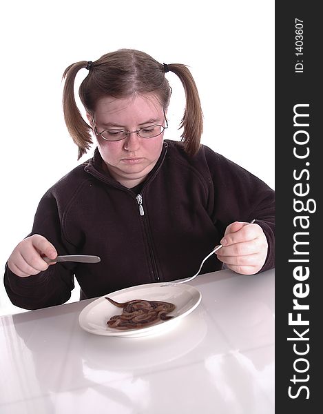 A woman eating a plateful of worms. A woman eating a plateful of worms.