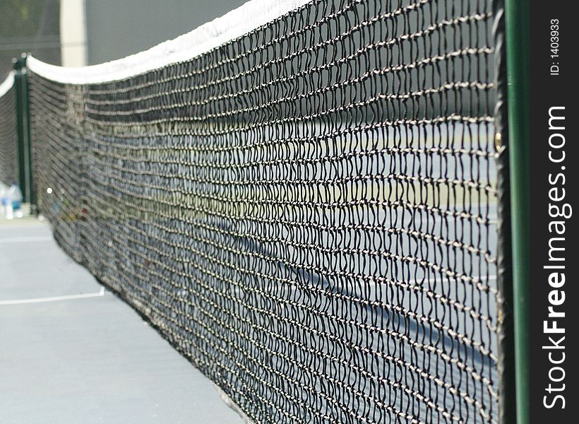 Selective focus image of tennis court net. could be used for sports and travel destinations or a background