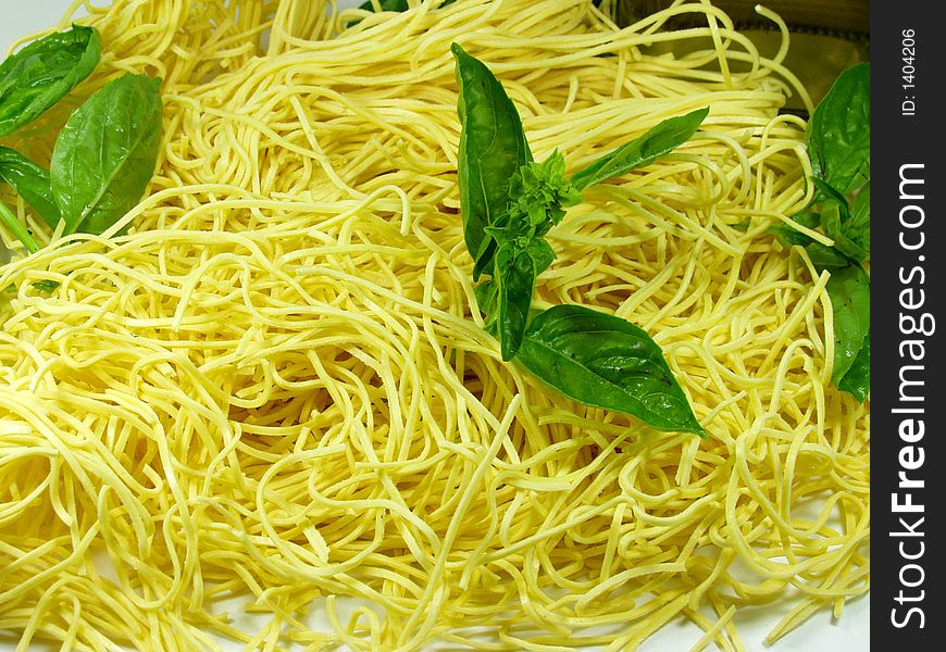 Spaghetti whit green fresh basil leaves. Typical italian food. Spaghetti whit green fresh basil leaves. Typical italian food