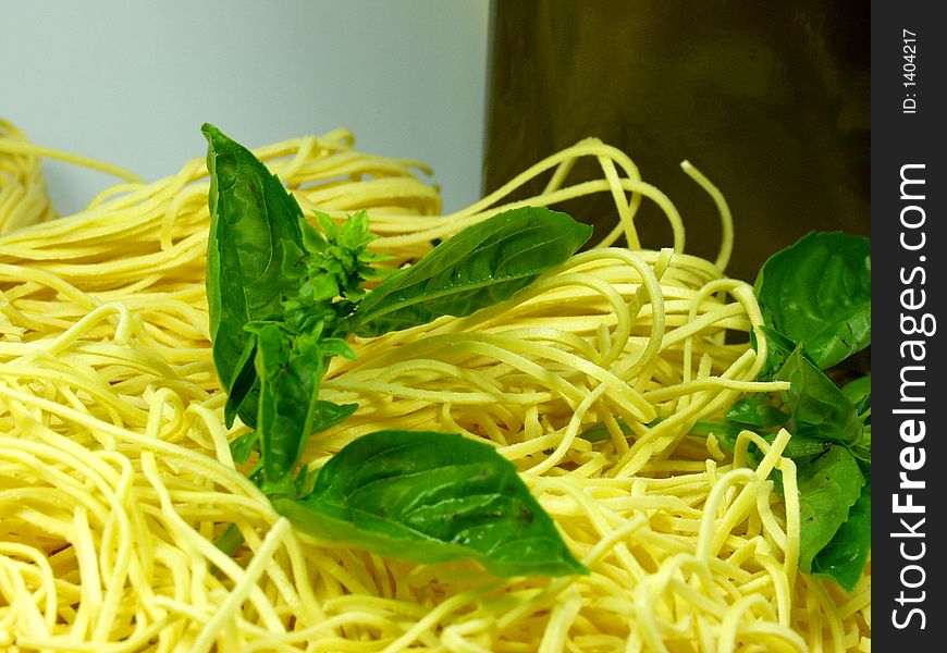 Spaghetti whit green fresh basil leaves. Typical italian food. Spaghetti whit green fresh basil leaves. Typical italian food