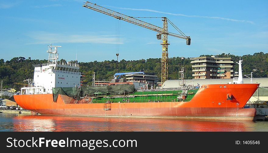 Big red cargo boat in shipyard. Big red cargo boat in shipyard...