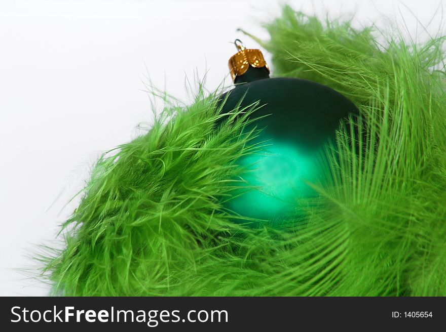 Green christmas decoration with ball and feathers