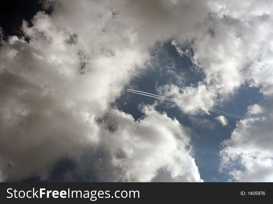 Airplane in sky with clouds.