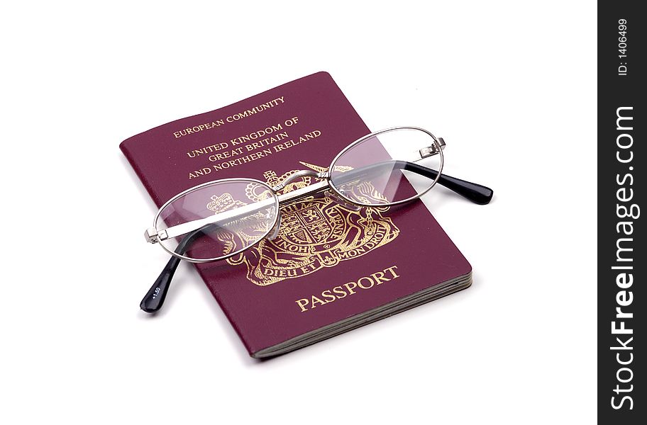 A British passport and glasses isolated against a white background. A British passport and glasses isolated against a white background.