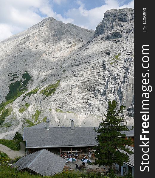 Alpine hut under the peak of a mountain