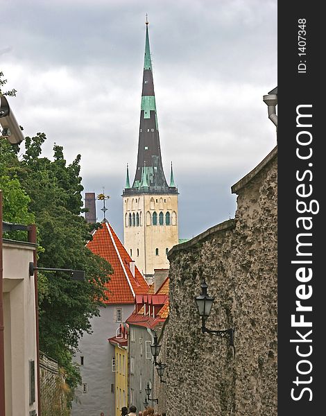 A Narrow alleyway leading to cathedral spire in Tallinn, Estonia. A Narrow alleyway leading to cathedral spire in Tallinn, Estonia