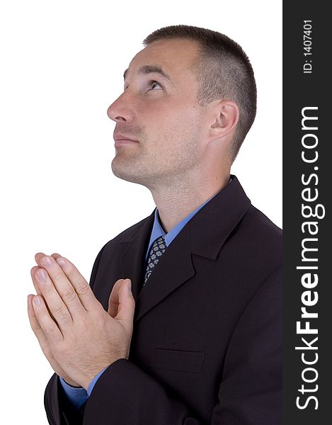 A business man is praying. A business man is praying