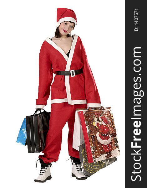 Young woman in  a red and white santa fancy dress with presents. Young woman in  a red and white santa fancy dress with presents