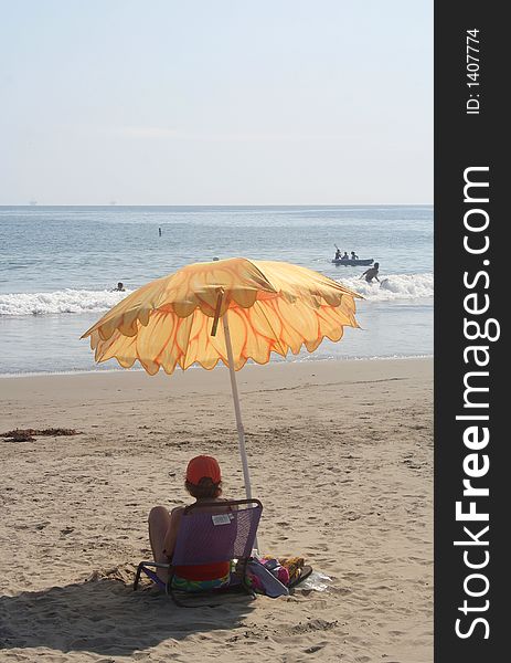 Relaxing under an umbrella on Californian beach. Relaxing under an umbrella on Californian beach