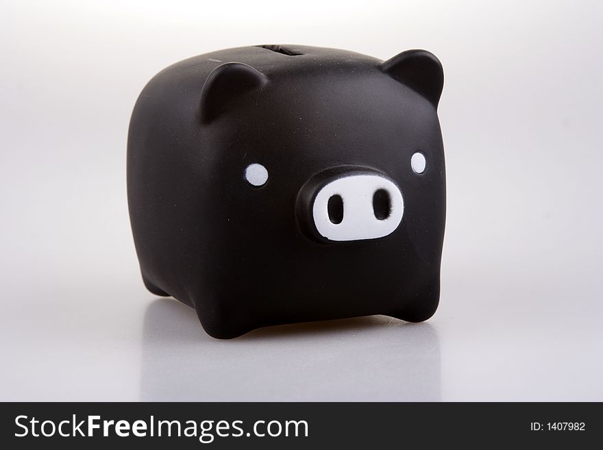 Black piggy bank in white background.