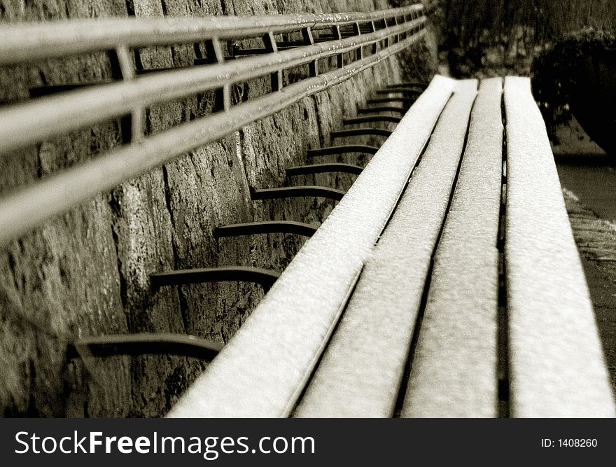 Photo of a long bench in a winter time