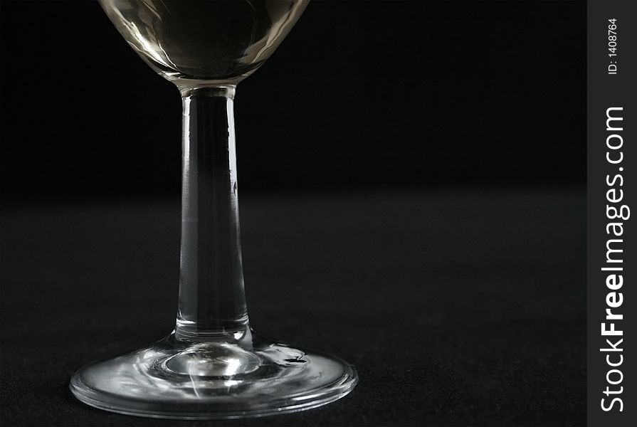 Minimal wine glass stem with white wine on it