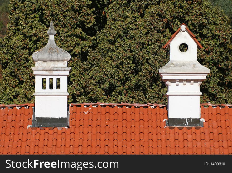 Ornamental chimneys on red roof