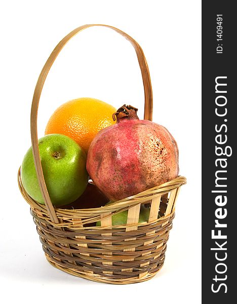 Basket with fruit. Apples, grapefruit and pomegranate.