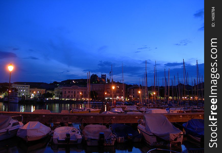 Italian lake port image and blue evening sky