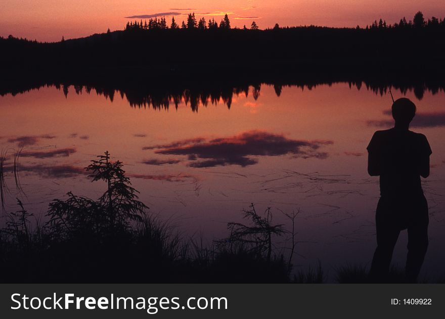 Silhouette of angler in the sunset