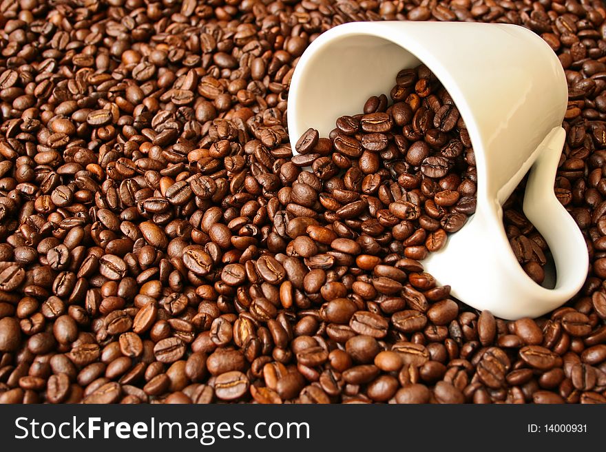 Fresh coffee beans with a white cup background texture