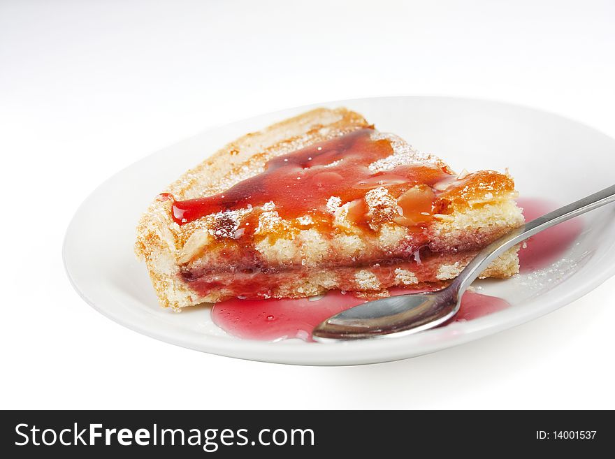 Bakewell tart with raspberry sauce isolated on white. Bakewell tart with raspberry sauce isolated on white