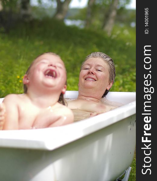 Mother and daughter taking a hot bath outdoor. Mother and daughter taking a hot bath outdoor