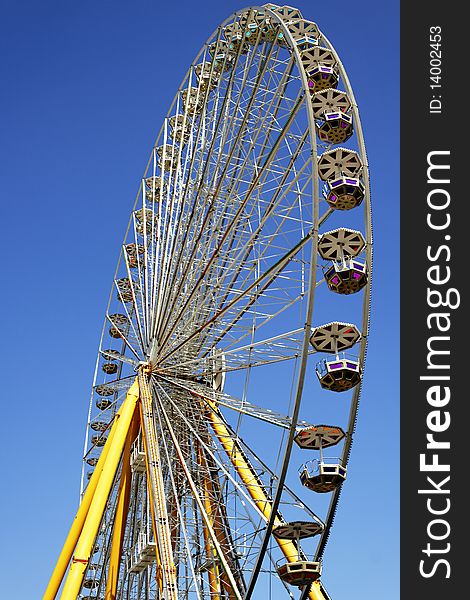 Yellow Ferris wheel and the blue sky