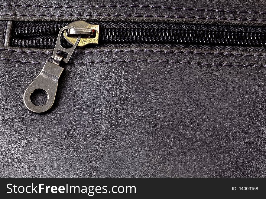 Leather background with metal zip