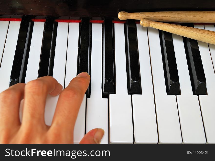 Left Hand Playing On Piano Keyboard