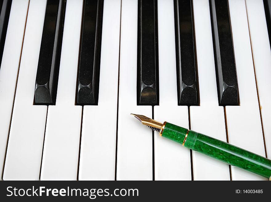 Black and white piano keyboard with fountain pen on the keys. For concepts such as music and creativity. Black and white piano keyboard with fountain pen on the keys. For concepts such as music and creativity.