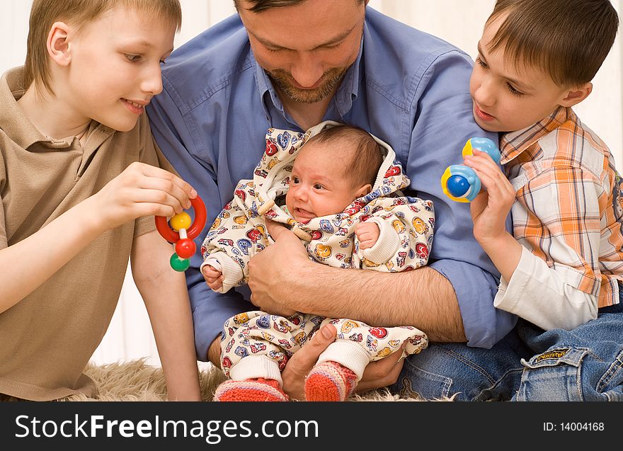 Happy dad plays with his three children. Happy dad plays with his three children
