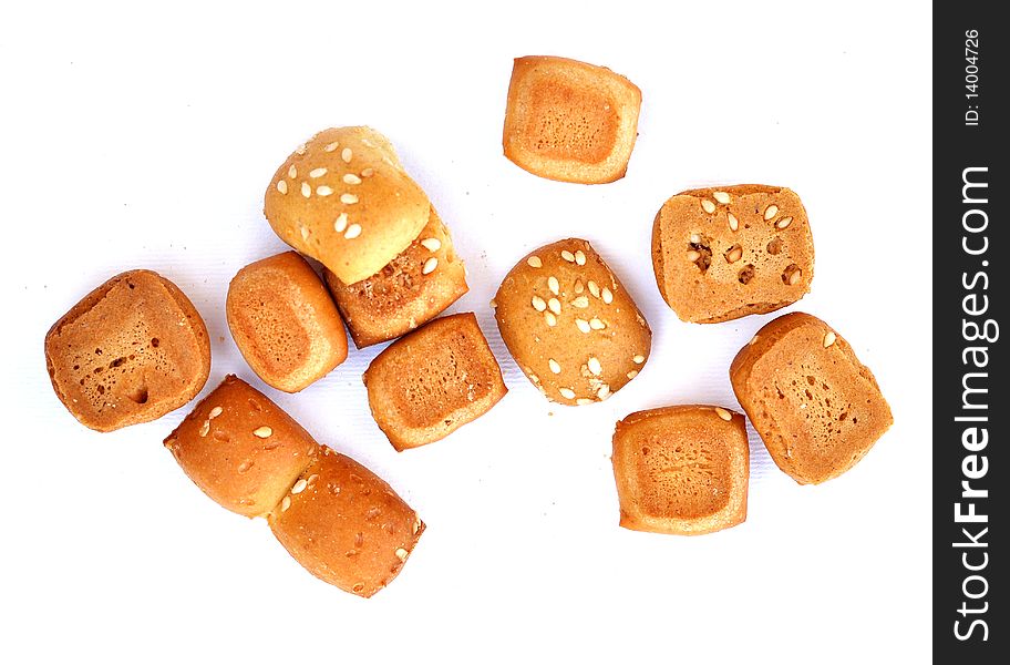 A cookie made of flower, oil, water and yeast with some sesame seeds. A cookie made of flower, oil, water and yeast with some sesame seeds