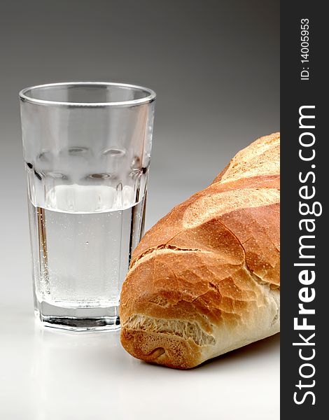 Piece of bread with glass of water